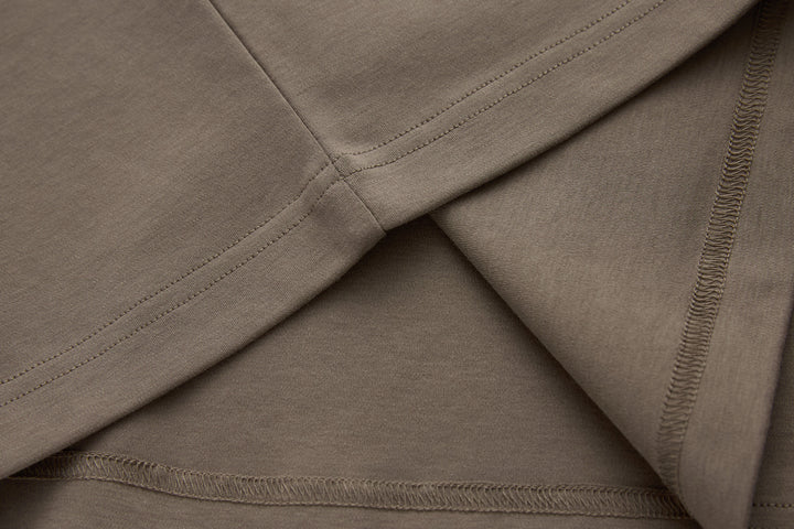 Walnut brown t-shirt sleeve and hem seam stitching close-up