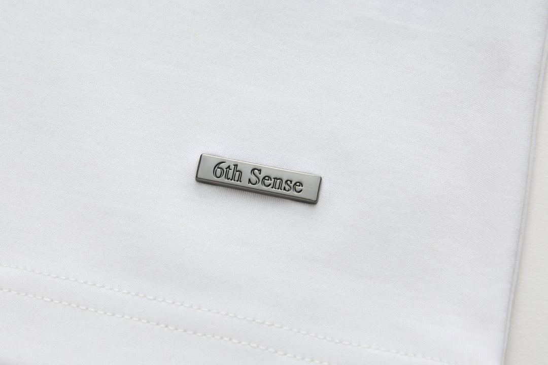 White crewneck T-shirt with 6th Sense stitched logo label