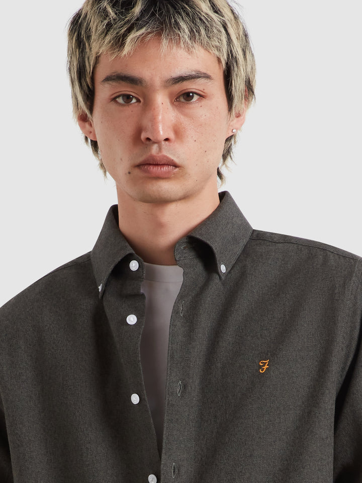 Dark charcoal long-sleeve shirt with button-down collar and small chest logo