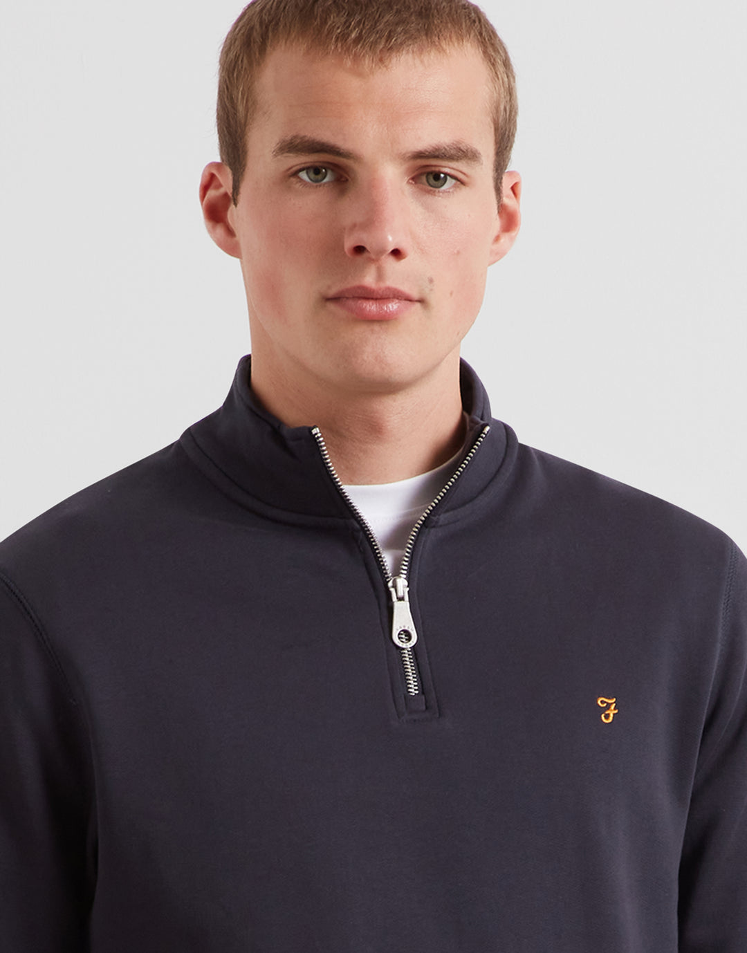 Navy 1/4-zip top with quarter zip collar and small chest logo detail
