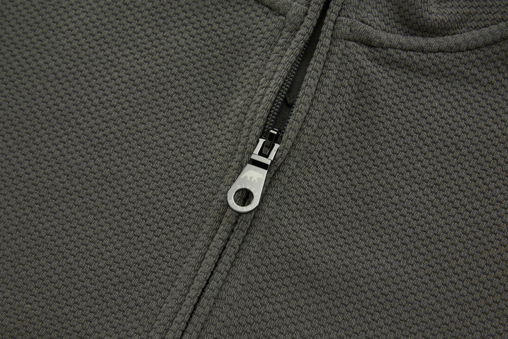 Grey 1/4-zip top zipper close-up with metal pull tab