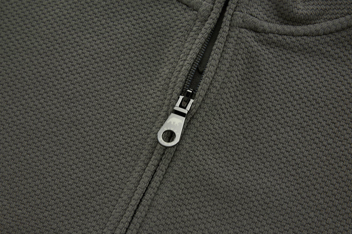 Grey 1/4-zip top zipper close-up with metal pull tab