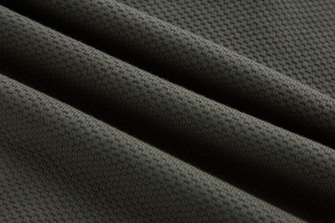 Grey 1/4-zip top fabric close-up with knit texture and seams