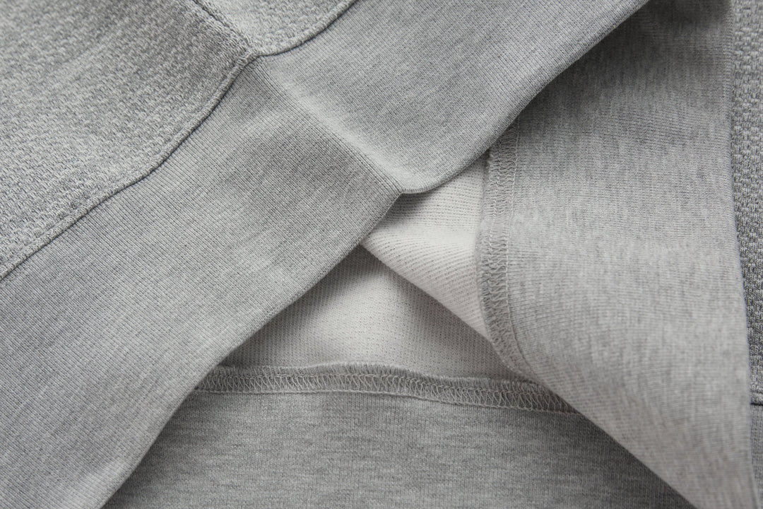 1/4-zip top folded detail showing inner seam and ribbed collar trim
