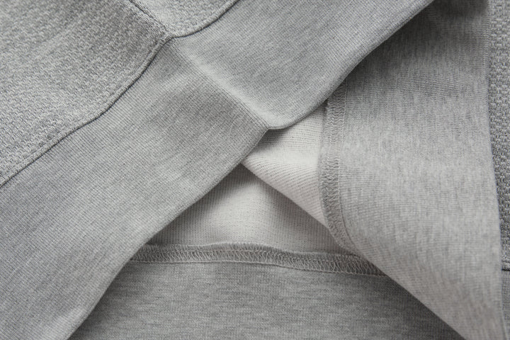 1/4-zip top folded detail showing inner seam and ribbed collar trim