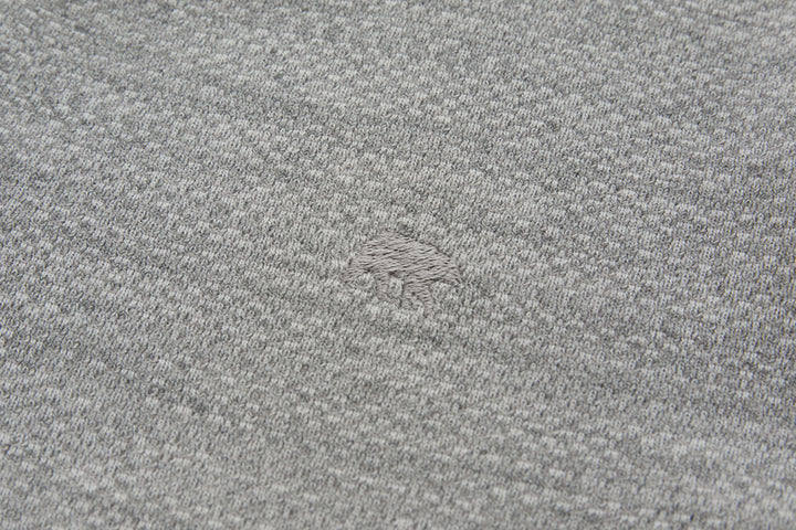 Heather gray knit 1/4-zip top fabric close-up with subtle texture
