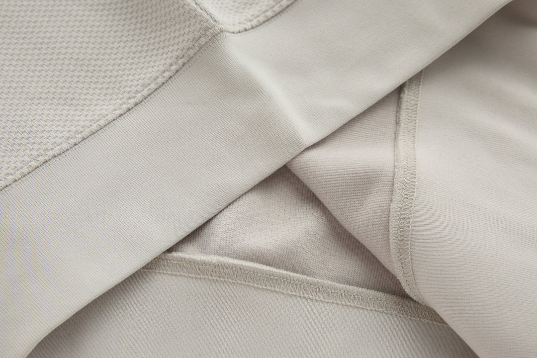 Light beige 1/4-zip top sleeve with ribbed cuff and inner seam