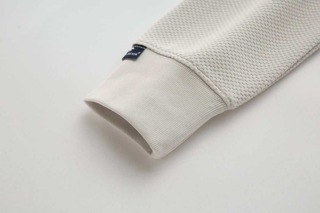 Light beige waffle-knit 1/4-zip top, ribbed sleeve cuff detail