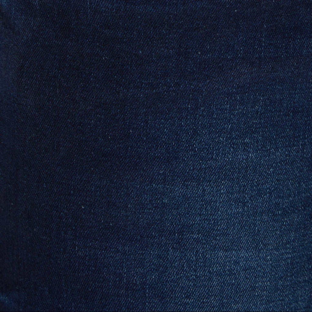 Dark blue jeans pocket close-up with stitched seams and metal button