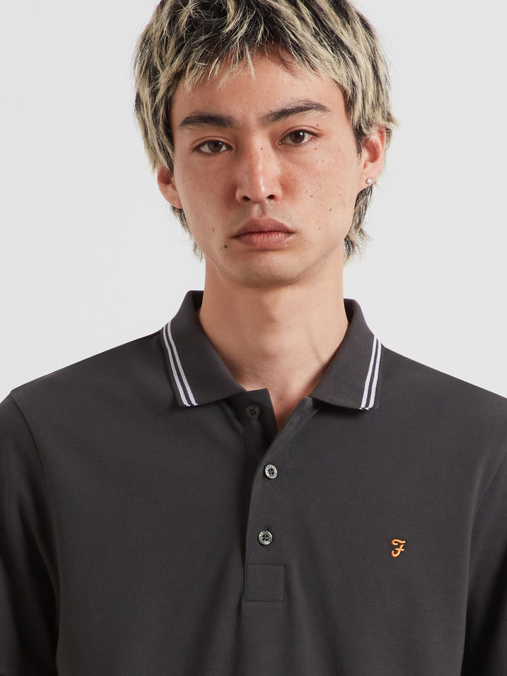 Farah washed black polo shirt close-up: striped collar tips and small chest logo