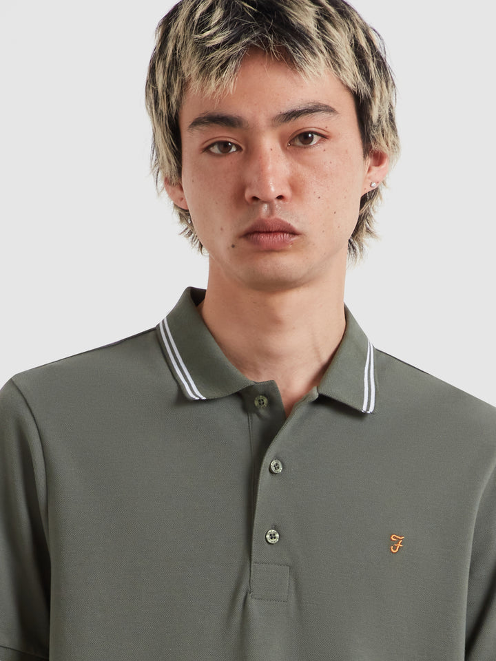 Olive green tipping polo shirt with striped collar and sleeve cuffs, button placket, logo