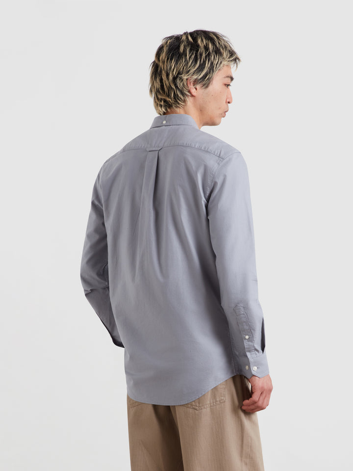 Men's slim-fit light blue Oxford shirt, back view with button-front and long sleeves.