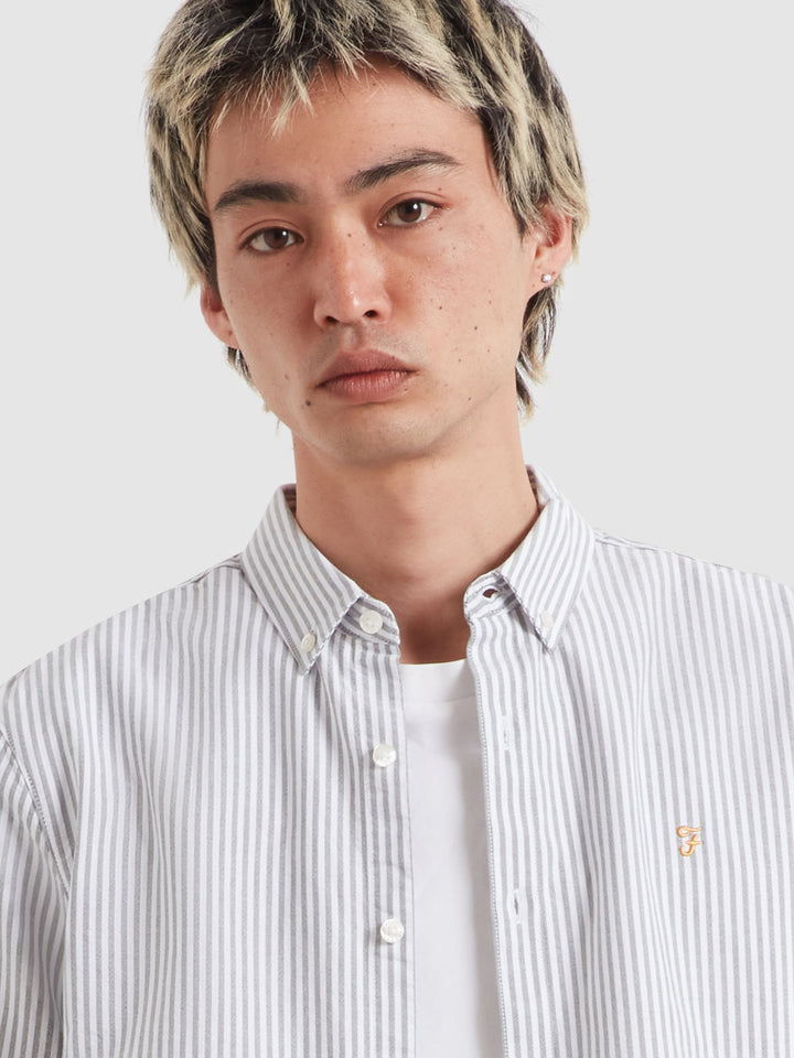 Striped long-sleeve button-up shirt with chest logo detail