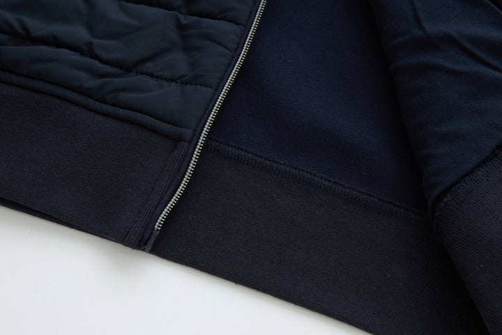 Navy hybrid jacket hem with ribbed knit cuff and zip front