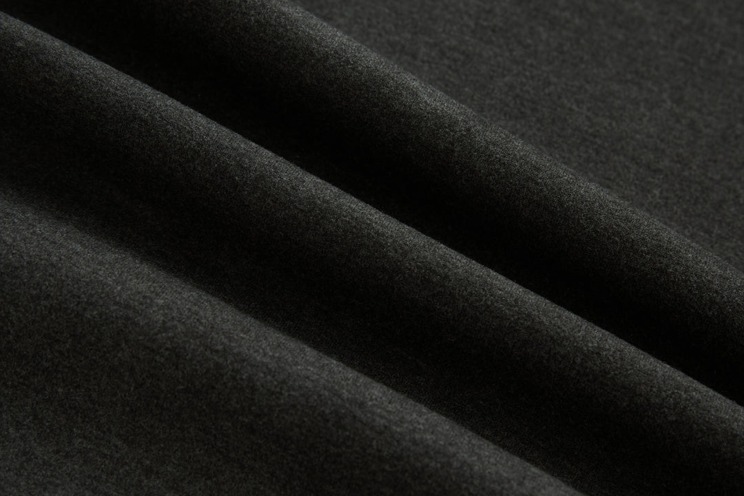 Dark knit fabric texture close-up on jacket sleeve panel