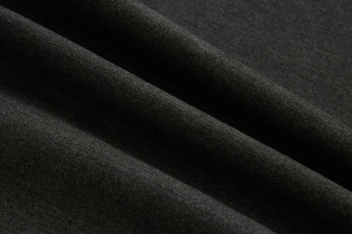 Dark knit fabric texture close-up on jacket sleeve panel