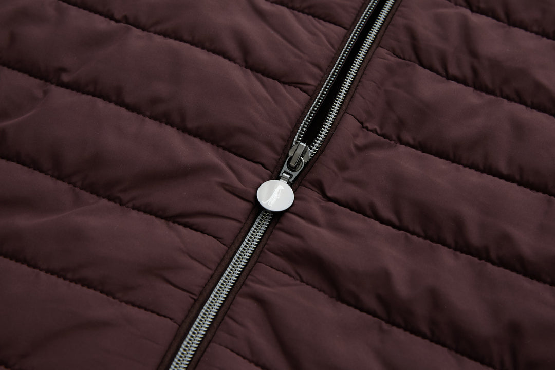 Plum zip pull and metal zipper on quilted jacket front