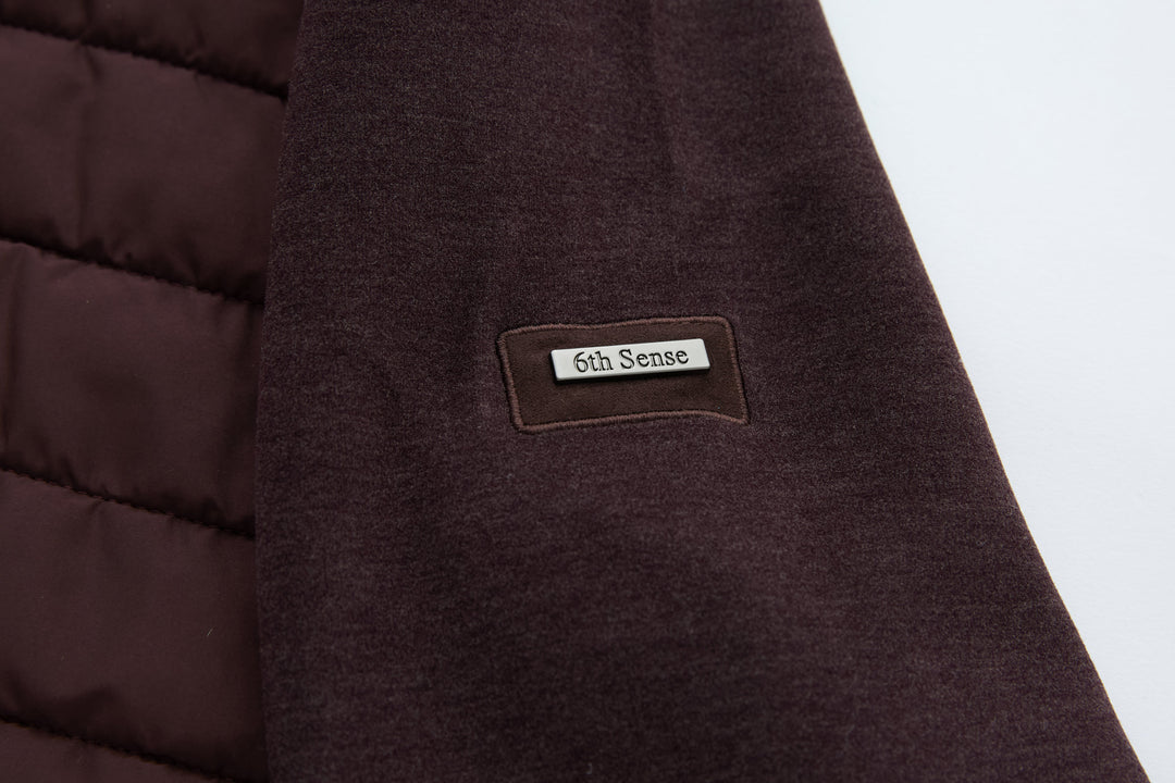 6th Sense logo patch on plum hybrid jacket shoulder