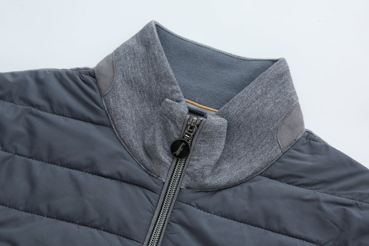 Hybrid jacket with gray hood collar and front zipper, dark quilted body