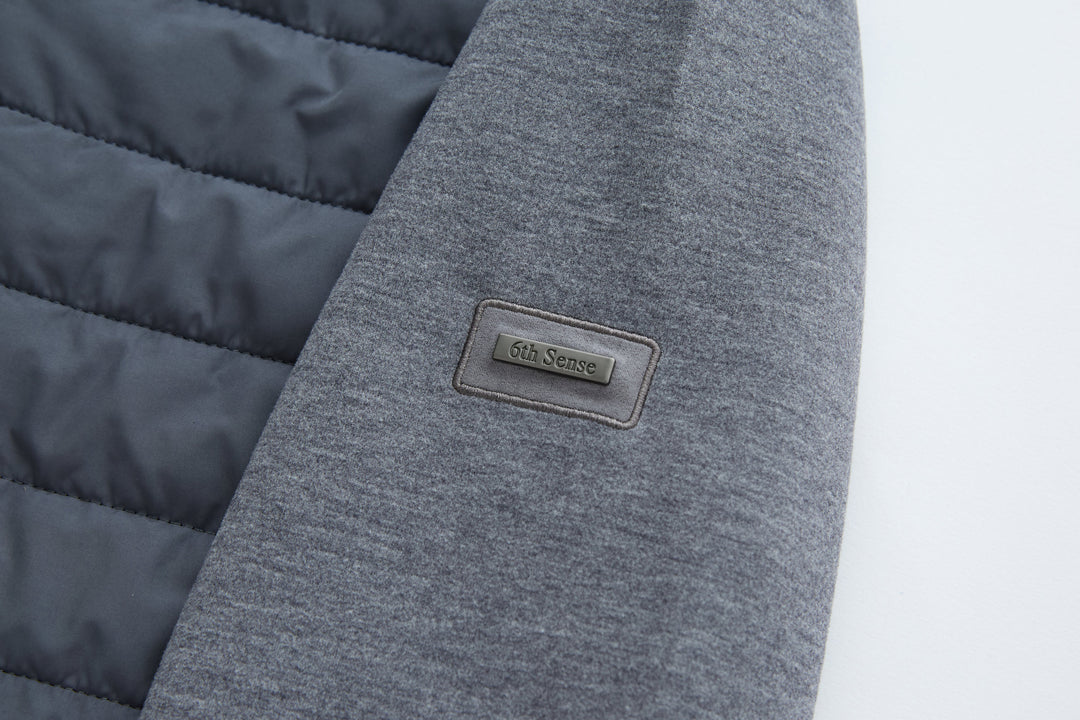 6th Sense hybrid jacket logo patch on gray knit sleeve