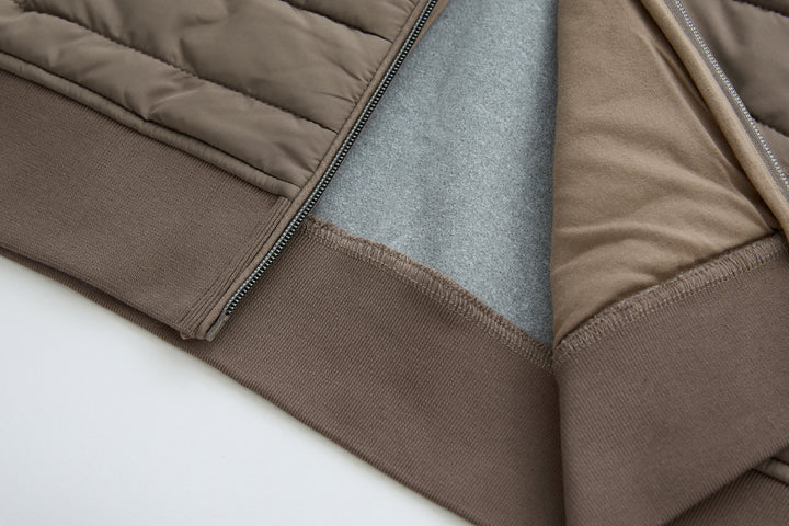 Taupe hybrid jacket hem with ribbed trim and seam detail