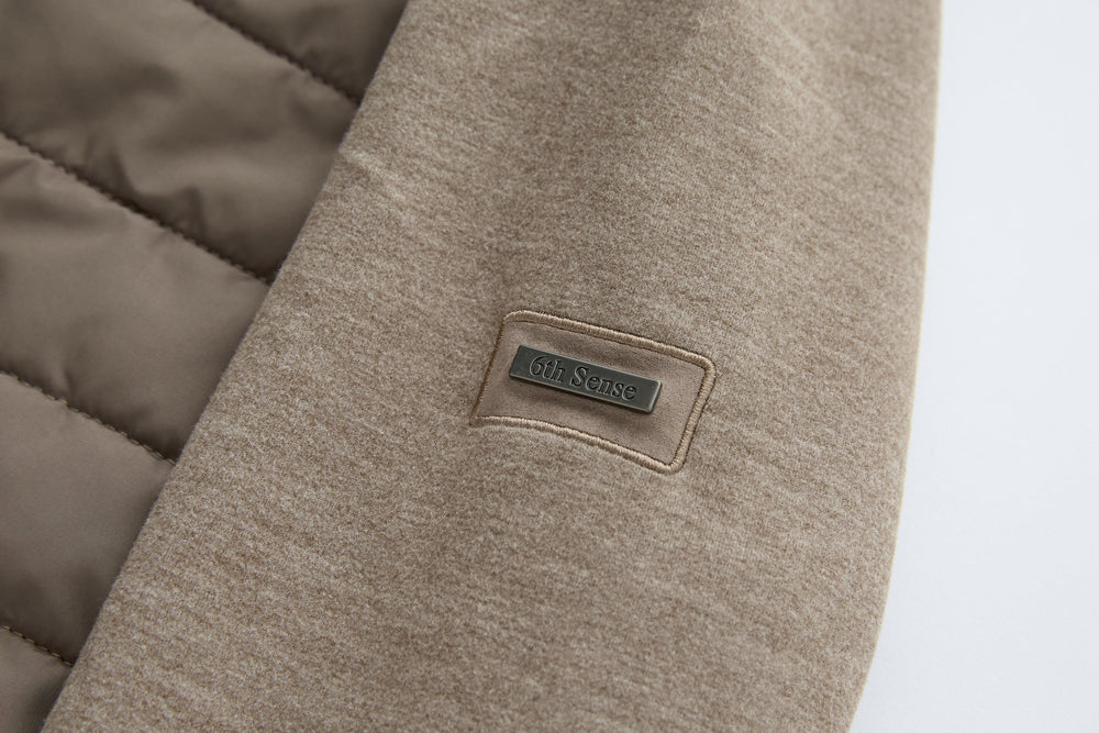 Taupe hybrid jacket sleeve with 6th Sense logo patch label