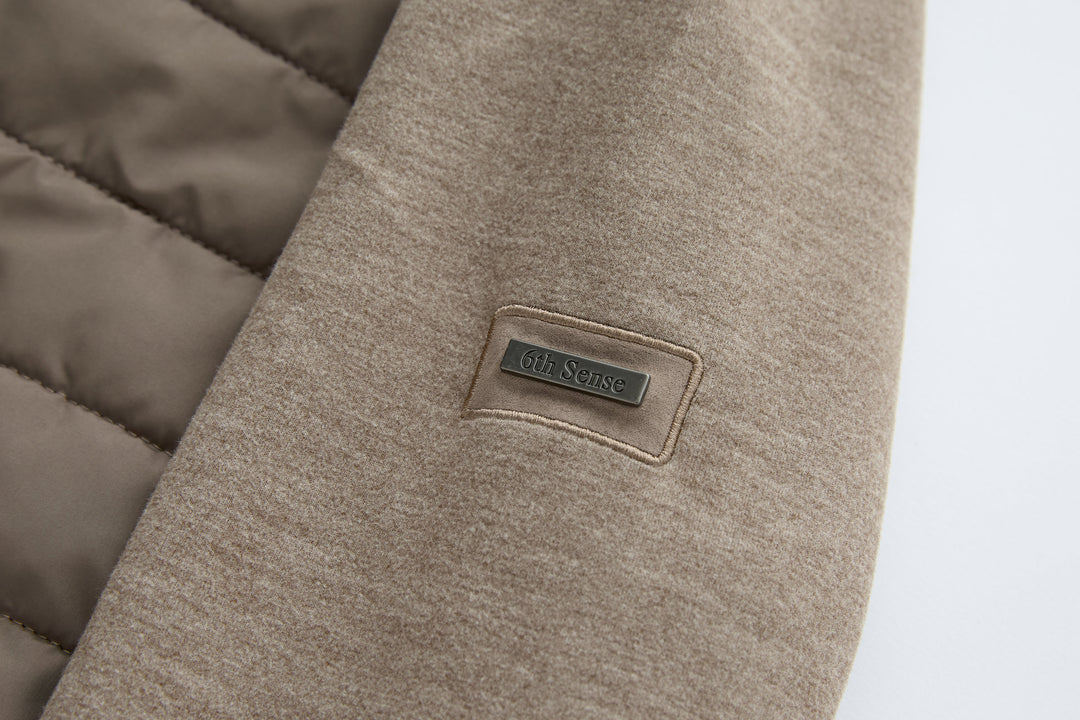 Taupe hybrid jacket sleeve with 6th Sense logo patch label