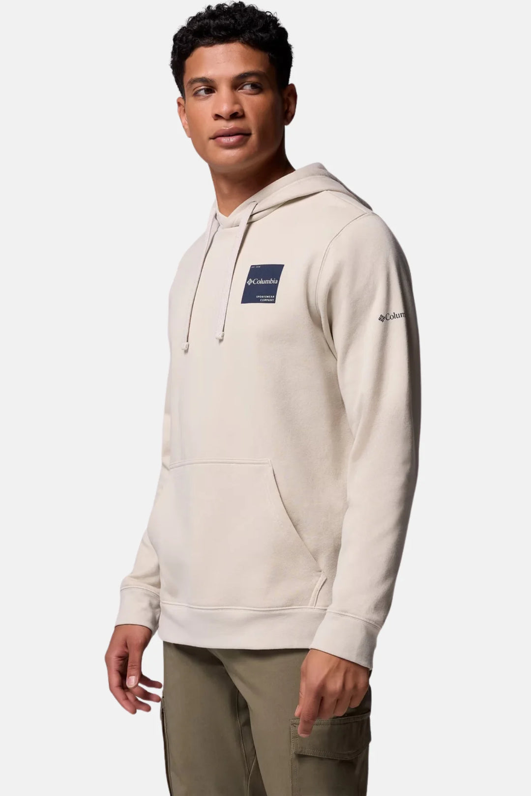 Men's light stone pullover hoodie with chest logo patch and side sleeve logo.