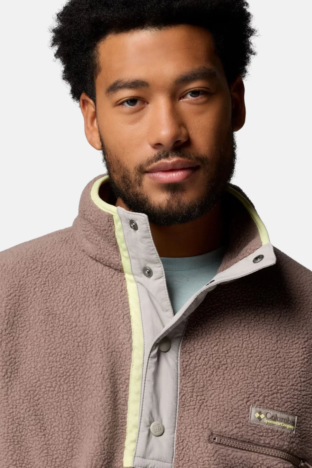 Half-snap fleece pullover close-up, taupe-brown with embroidered logo pocket