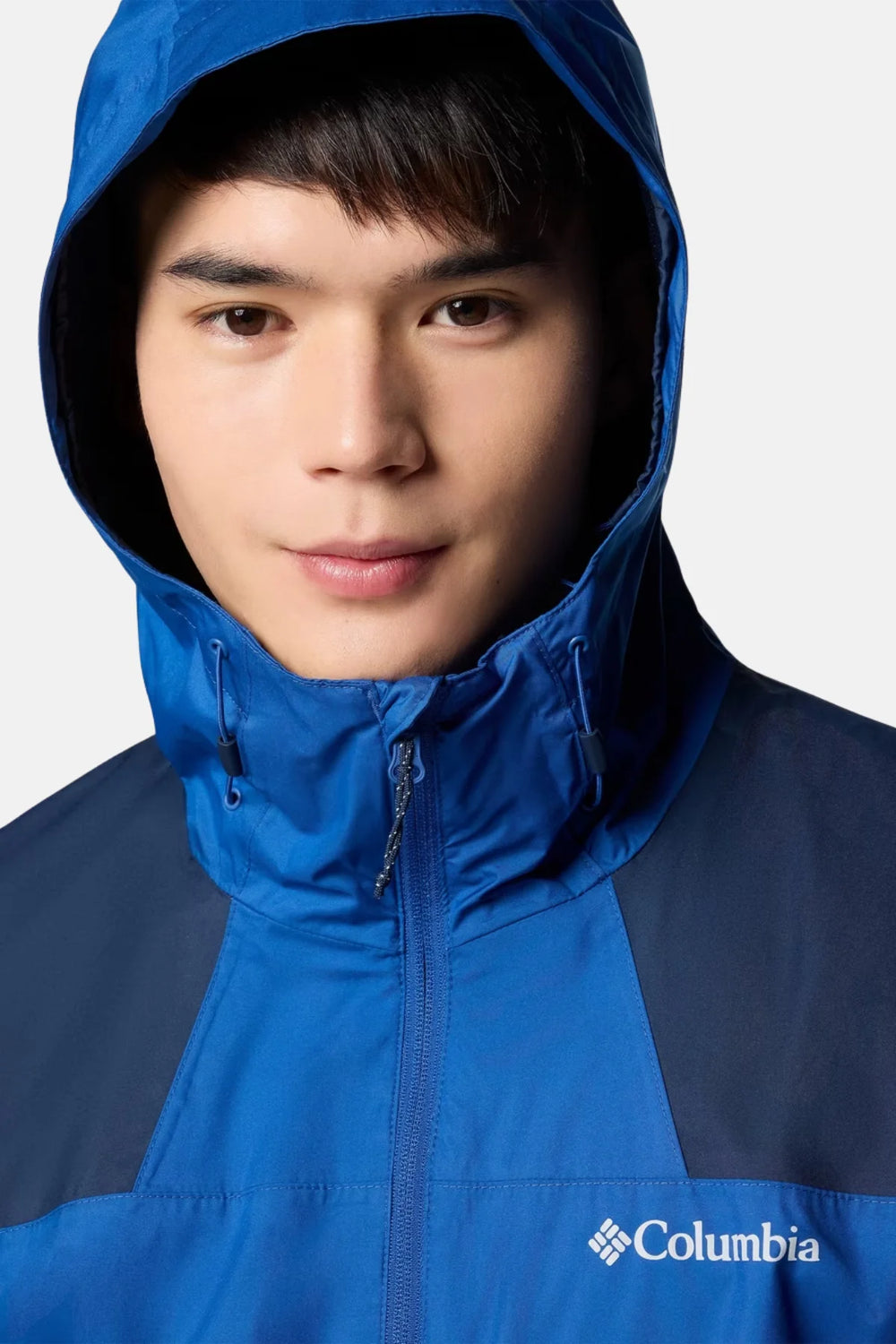 Waterproof hooded jacket close-up, blue shell with dark navy trim and full-zip front