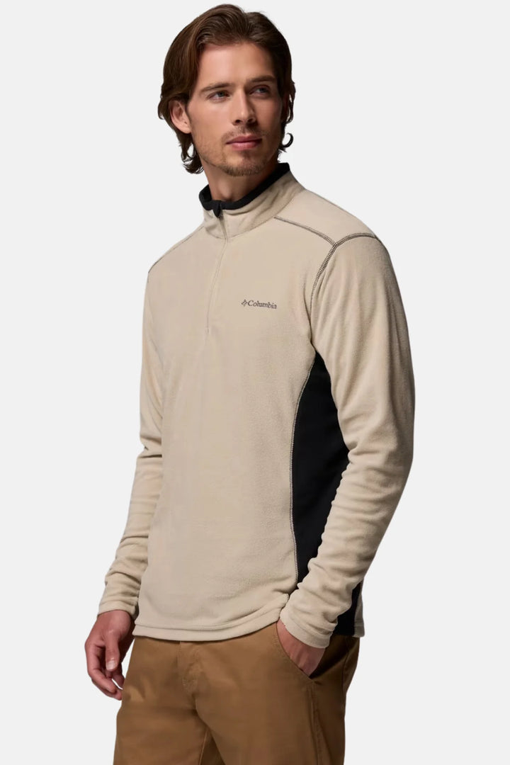 Half-zip fleece top in beige with dark paneling on sides and sleeves