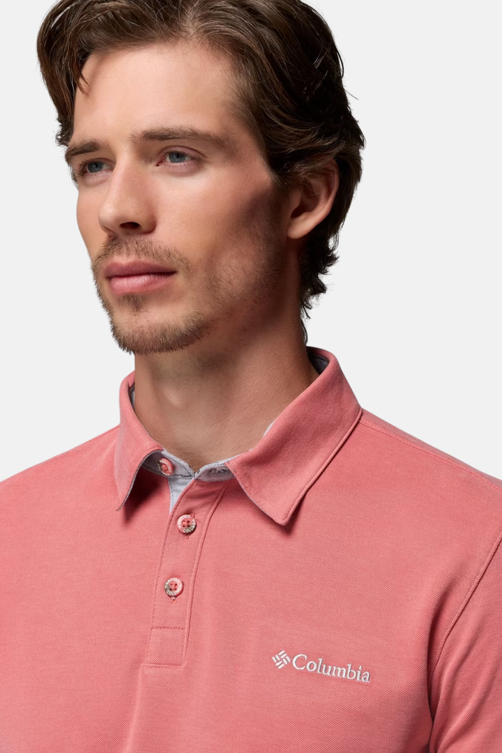 Washed red polo shirt close-up with buttoned collar and Columbia chest logo