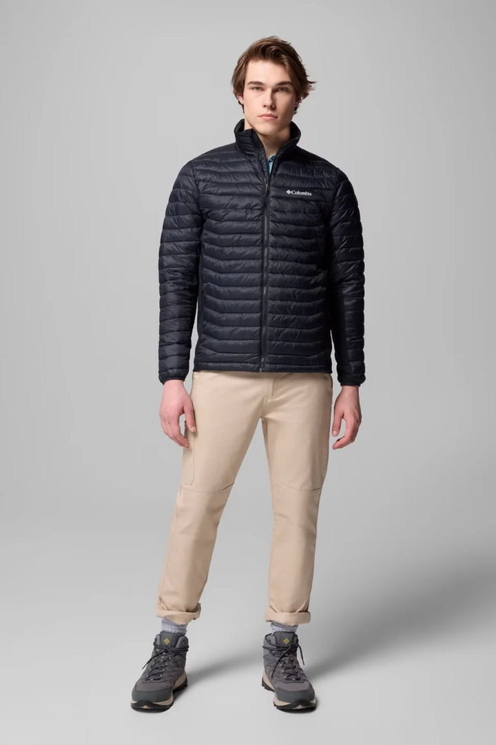 Dark insulated puffer jacket with full-zip front and stand collar, worn with beige pants