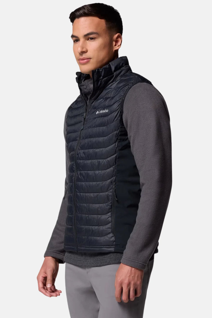 Black quilted puffer vest with full-zip front, side profile over long sleeves