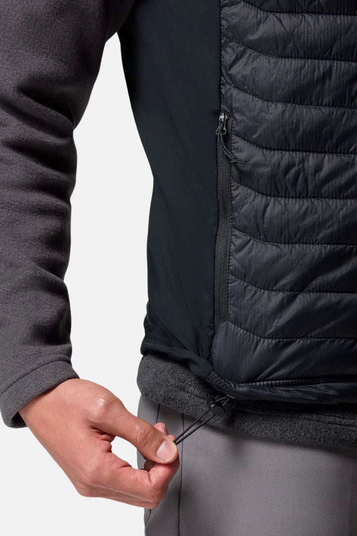 Black puffer vest detail showing full-zip and quilted stitching at side panel