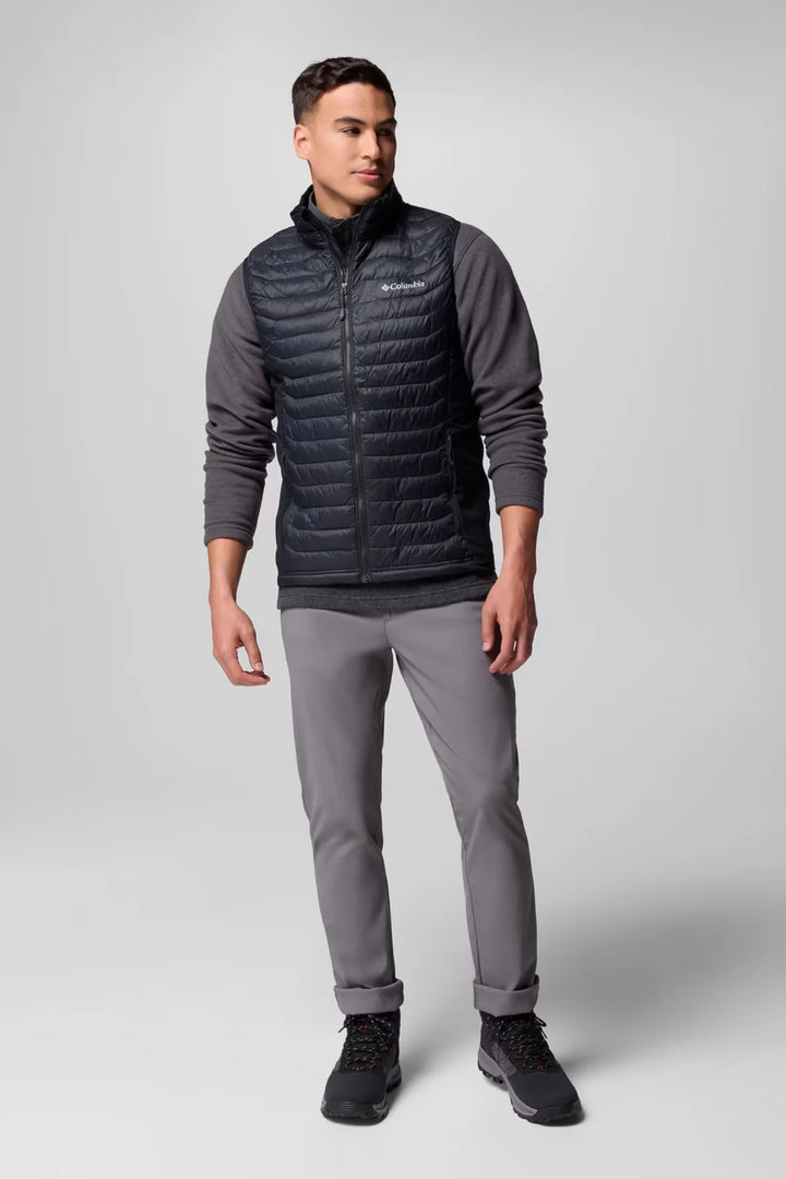 Black quilted puffer vest with stand collar, worn over long sleeves