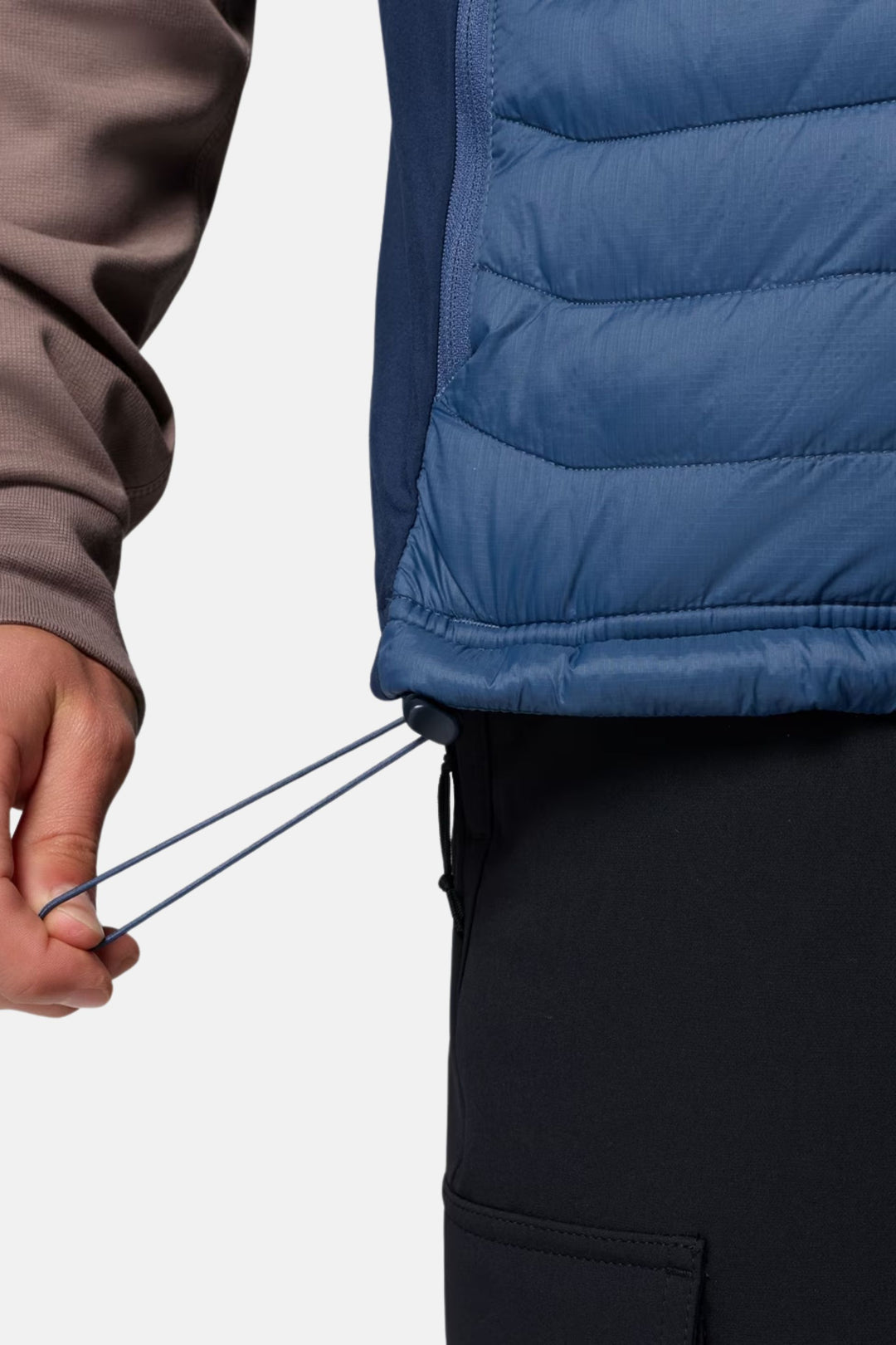 Blue puffer vest hem with drawcord and front pocket opening