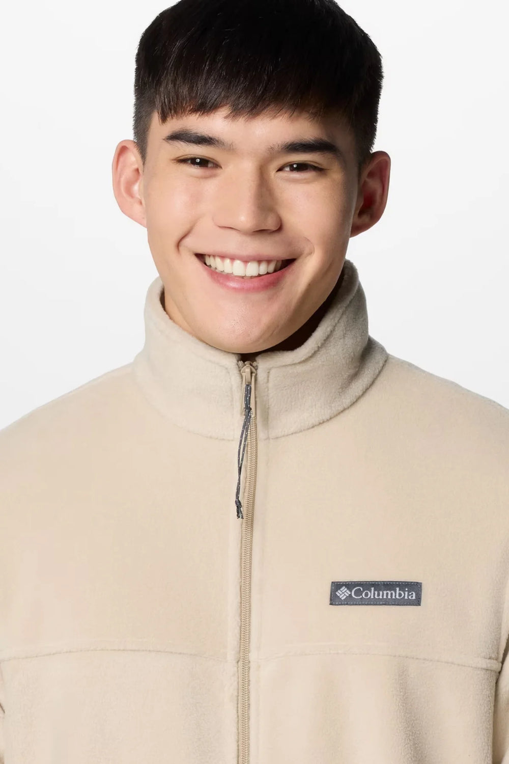 Beige fleece full-zip jacket close-up with logo patch and front zipper