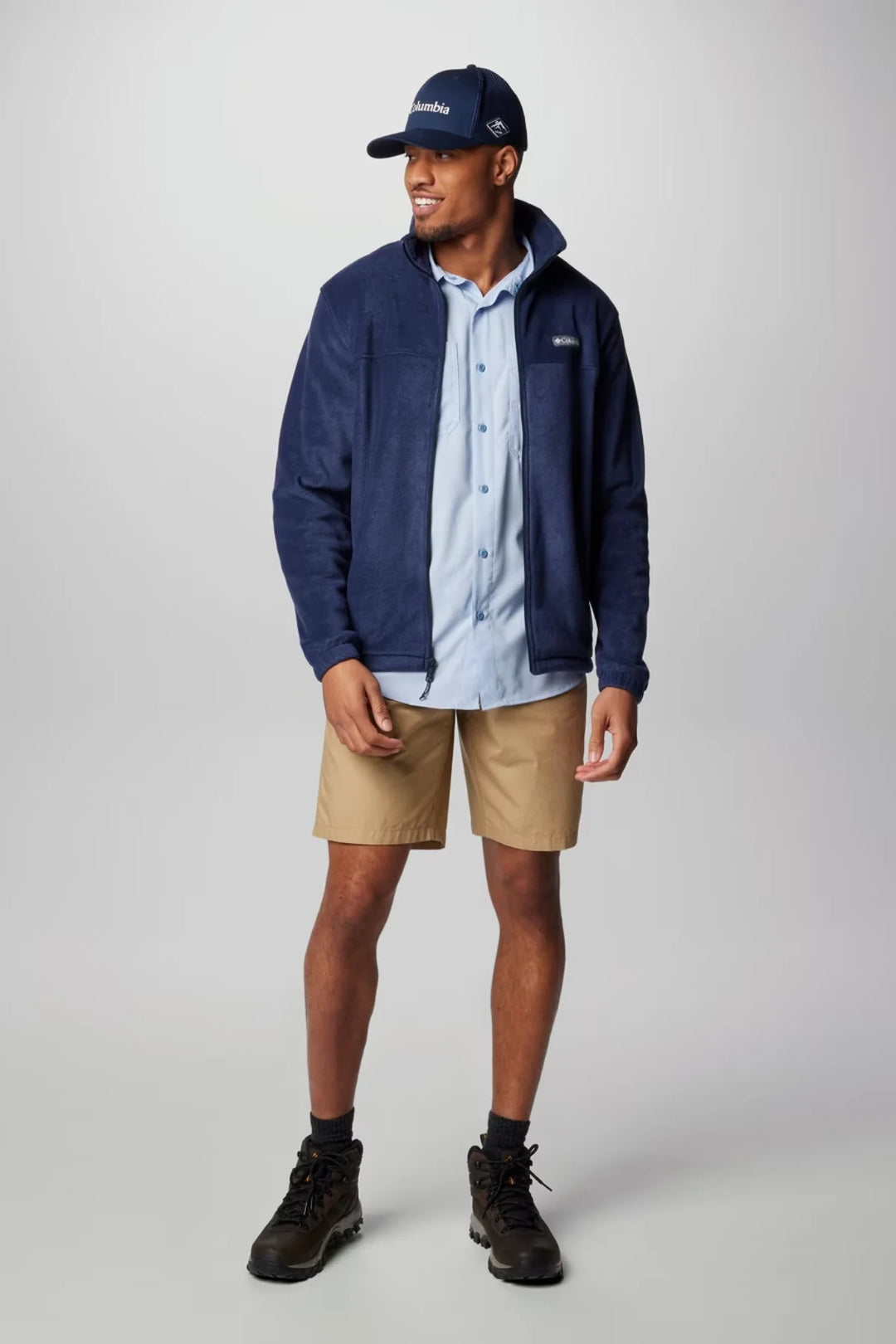 Columbia full-zip fleece jacket in collegiate navy, worn with beige shorts and cap
