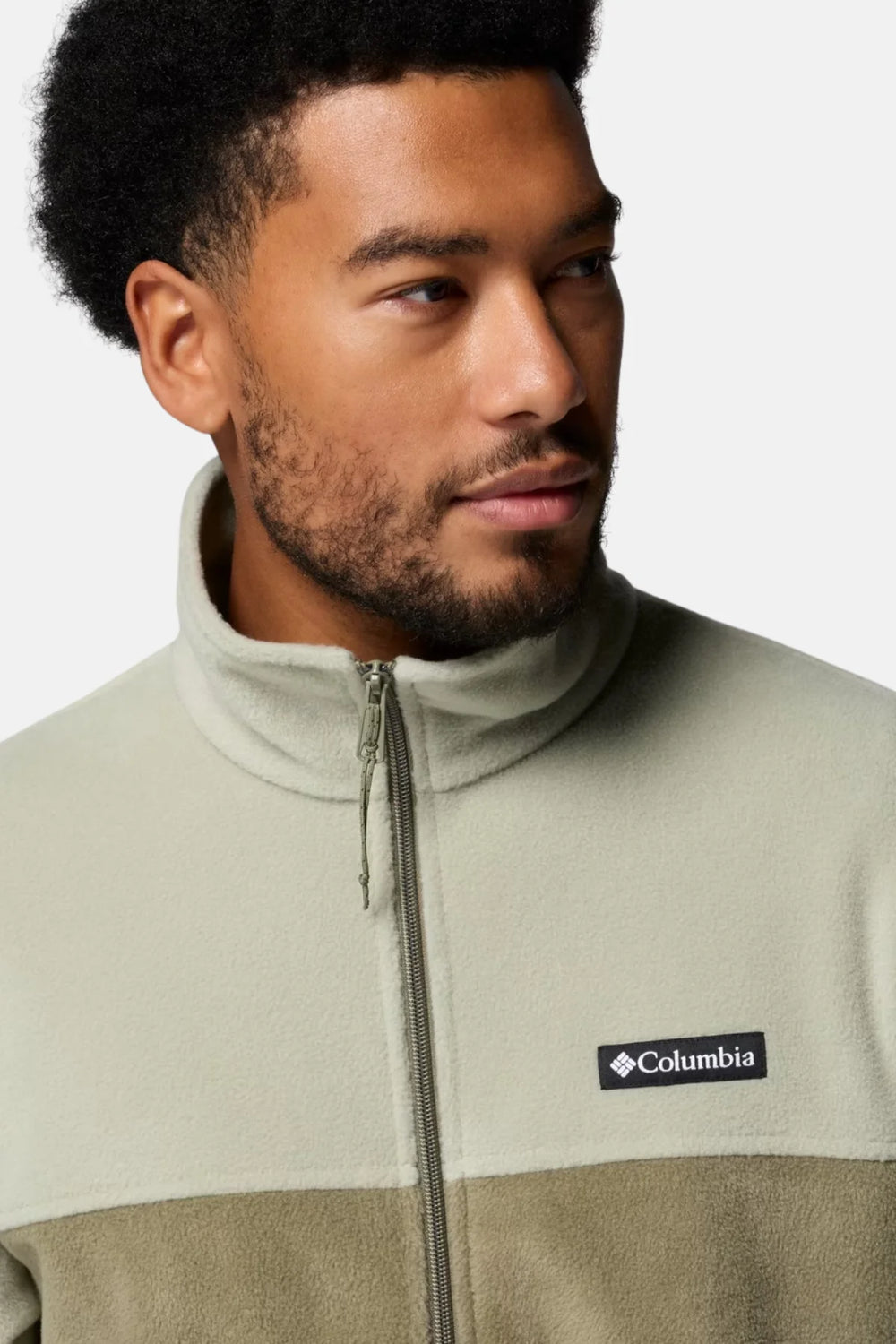 Men's fleece jacket close-up in light green and olive, zip-front with logo patch