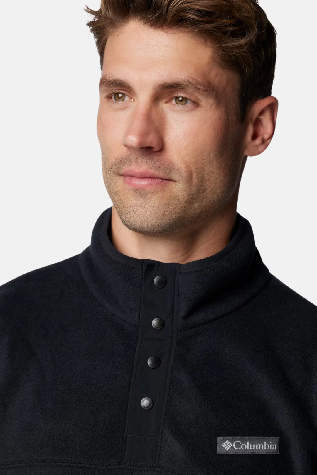 Men's black fleece half-snap pullover close-up of snap collar and logo patch