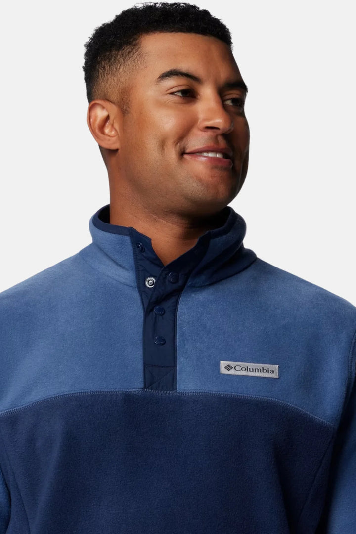 Men's blue fleece half-snap pullover close-up, stand collar and dark snap placket