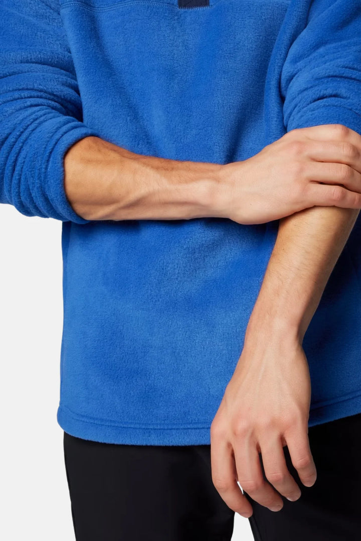 Blue fleece top sleeves and hem with hand near front pocket opening