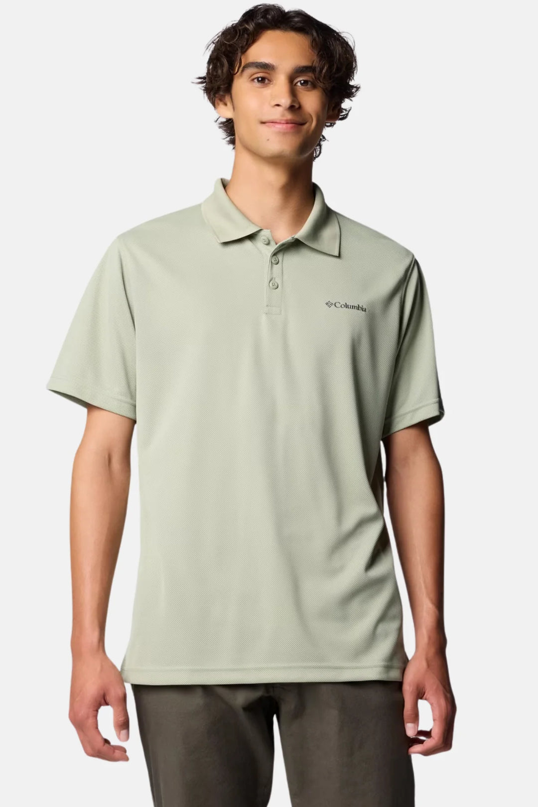 Men's Columbia polo shirt in light sage green with button placket and chest logo.