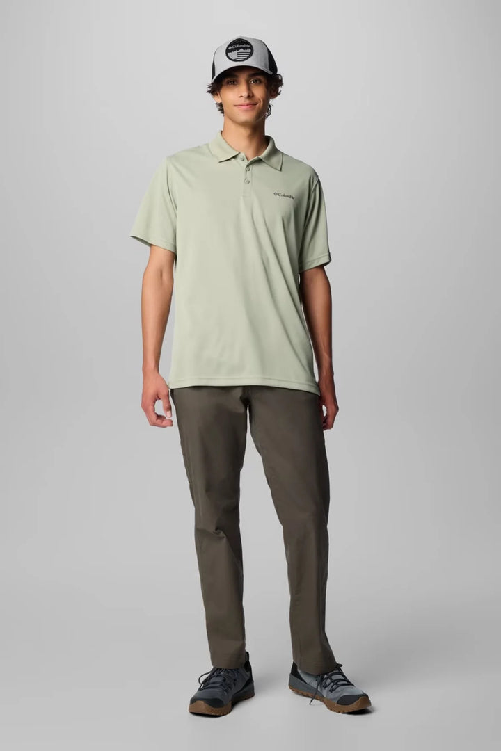 Sage green Columbia polo shirt with short sleeves and button placket, styled with dark pants.