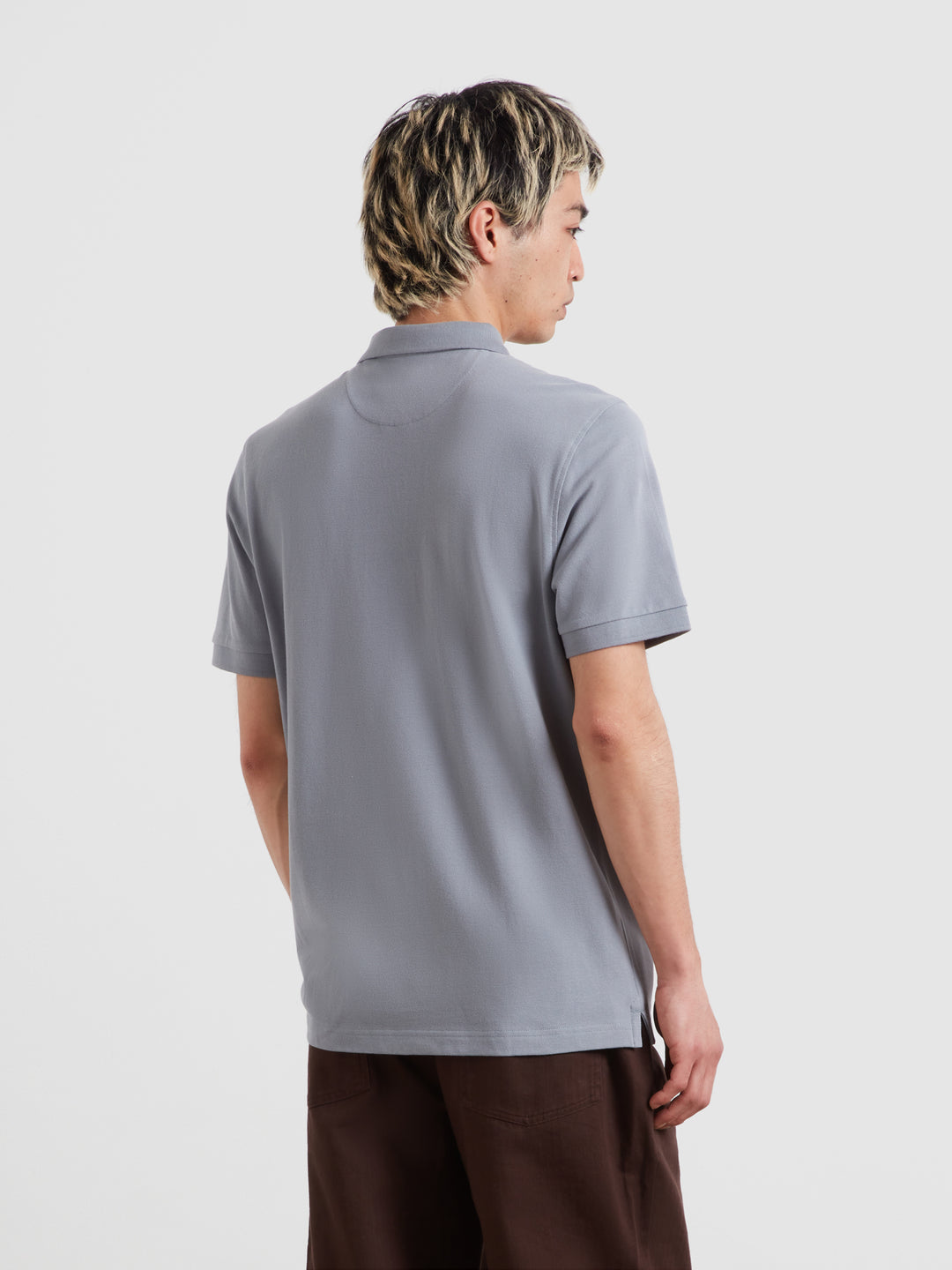 Light blue polo shirt back view with short sleeves and smooth collar