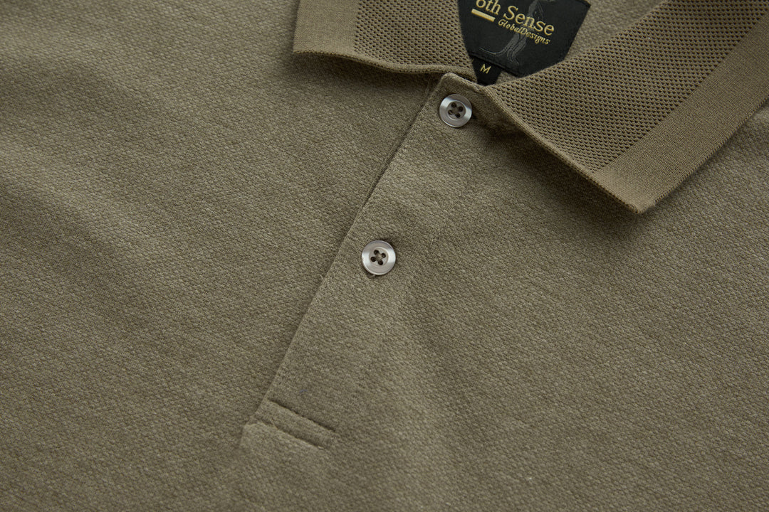 Brindle polo shirt front placket with two visible white buttons and textured fabric.