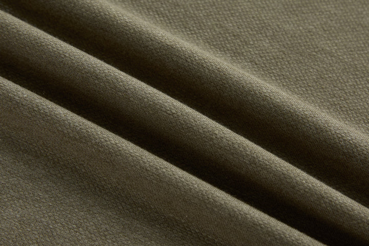 Brindle polo shirt knit fabric close-up with fine dotted texture.