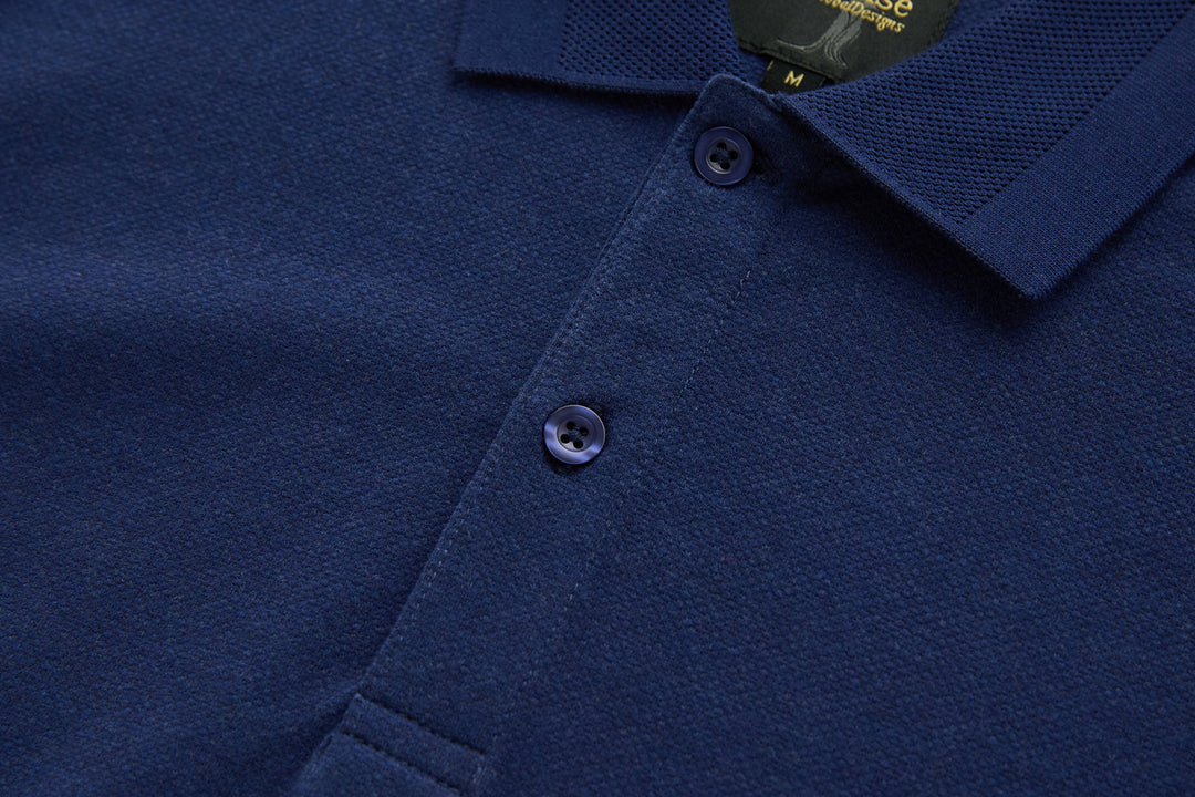 Dress blue polo shirt placket with two visible dark buttons