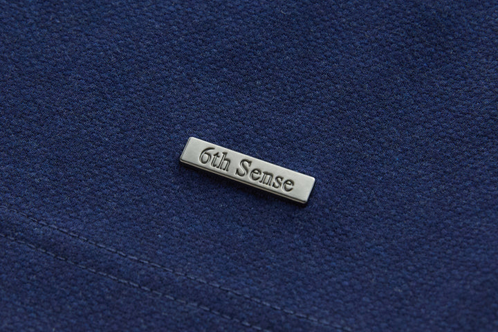 Dress blue polo shirt chest logo badge with visible seam stitching